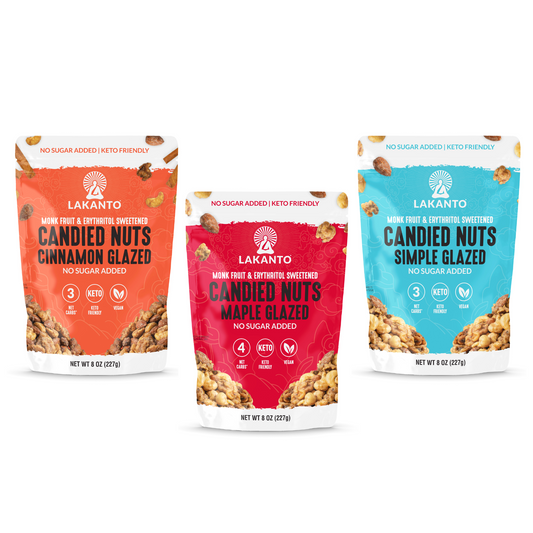 Three vibrant red, blue, and orange 8 oz (227g) bags of Lakanto Candied Nuts feature Maple Glazed, Simple Glazed, and Cinnamon Glazed flavors. The labels state No Added Sugar and Keto-Friendly.