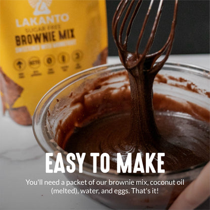 A hand stirs Keto-Friendly brownie batter in a glass bowl with Lakantos Sugar-Free Brownie Mix packaging in the background. Text overlay: Simple to Make! Just add coconut oil (melted), water, and eggs to our Sugar-Free Brownie Mix. Thats all!.