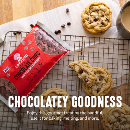 A package of Lakantos Sugar-Free Chocolate Chips rests on a cooling rack beside freshly baked cookies, ideal for keto-friendly indulgence. A broken cookie teases its chocolatey goodness, while a cup of coffee waits to enhance your peaceful moment.